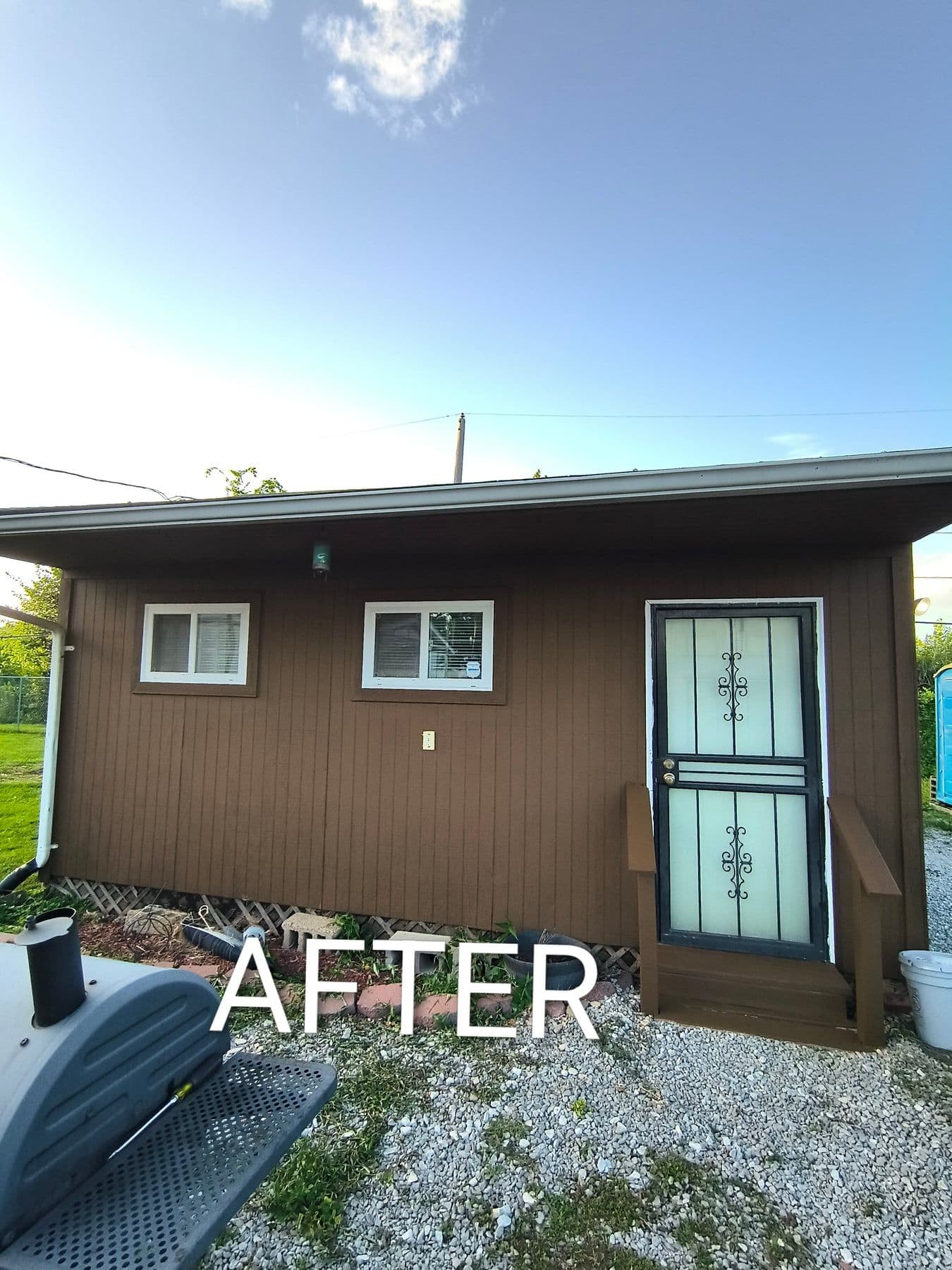 Garage exterior after repainting in brown with white trim