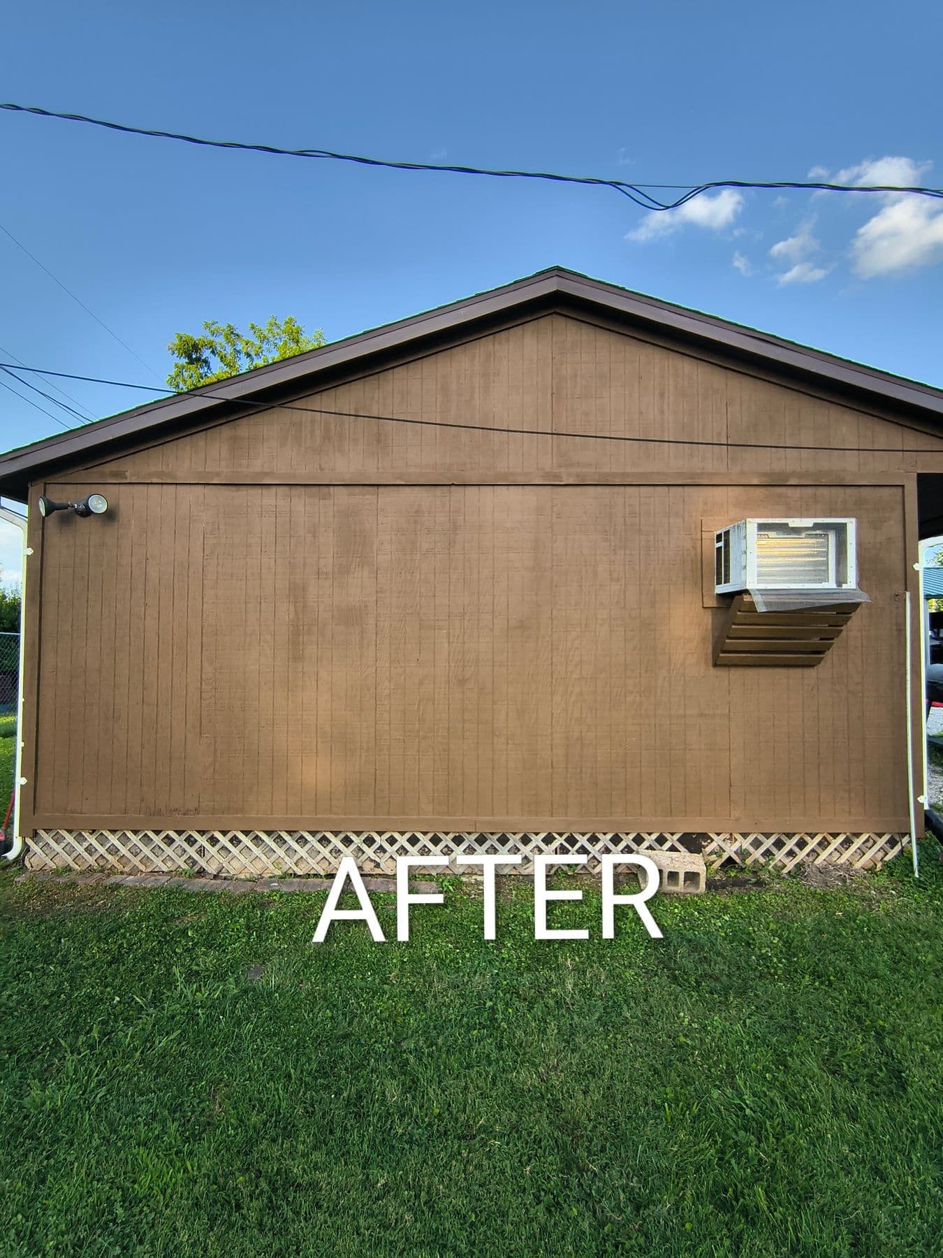 Garage wall repainted brown around a window air conditioner