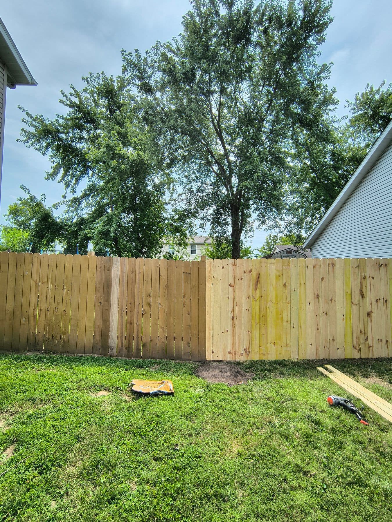 New wood privacy fence corner in a backyard
