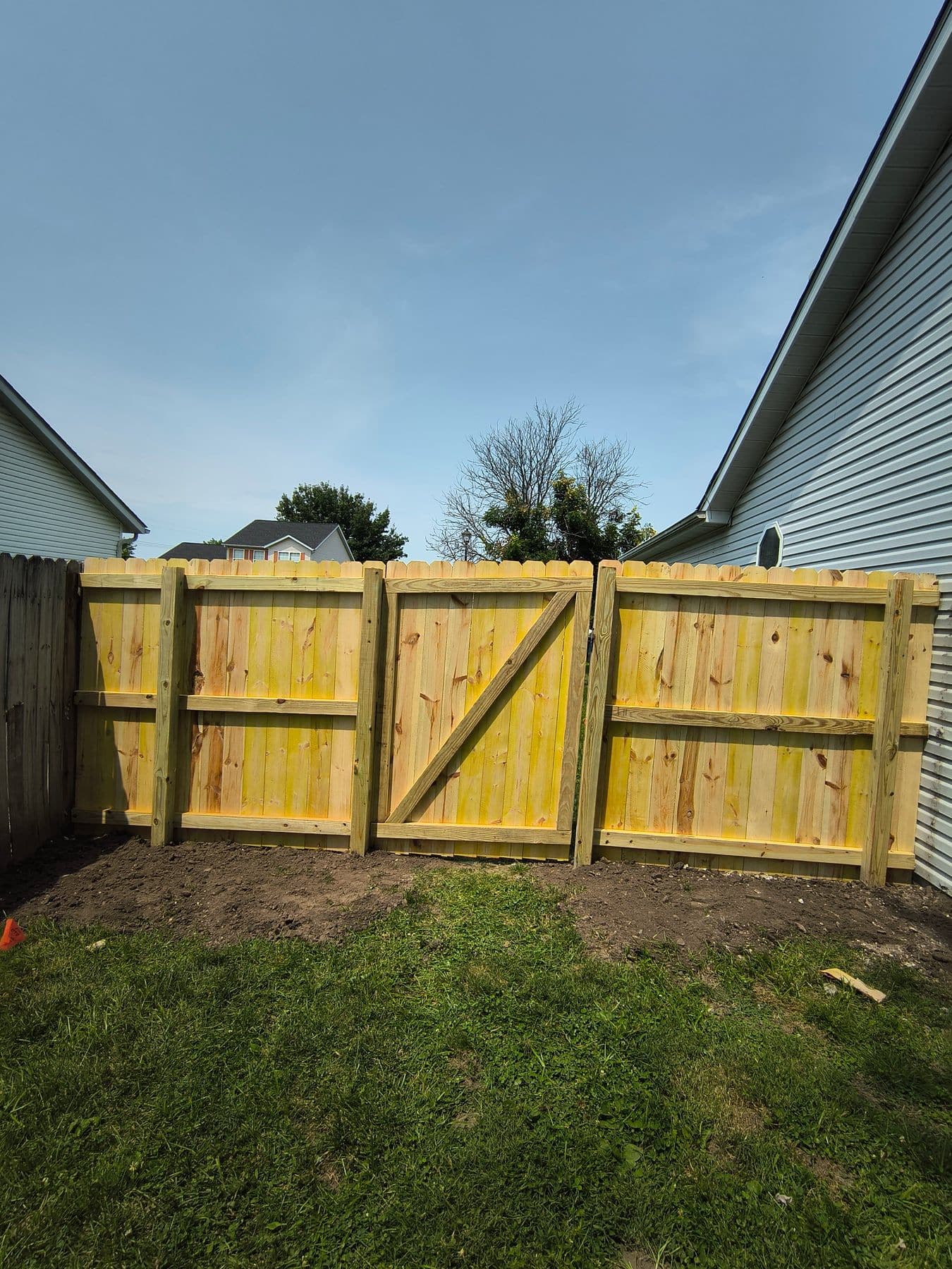 New wood fence with a double gate